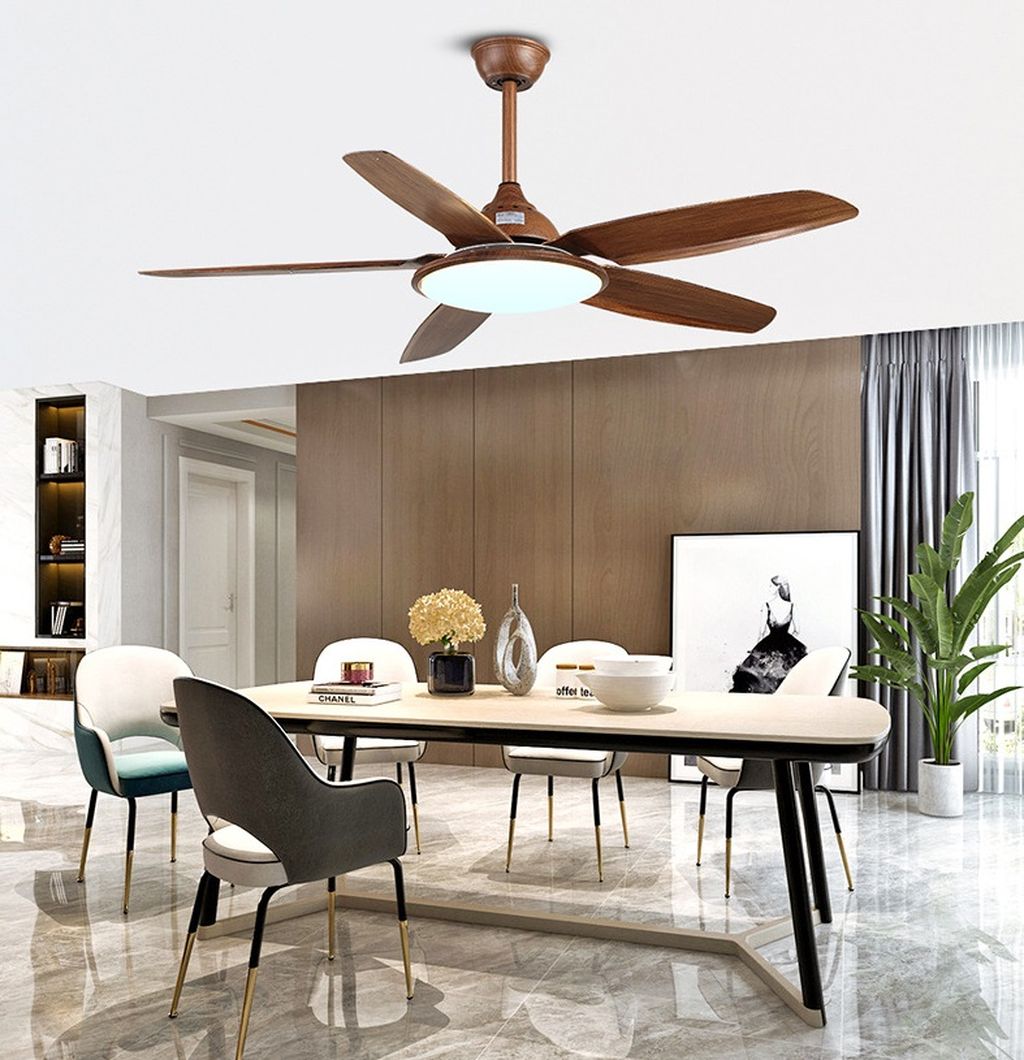 Quạt trần đèn led sở hữu thiết kế cánh gỗ mềm mại, tạo hiệu ứng chuyển động uyển chuyển và êm ái. Sắc nâu trầm của gỗ tự nhiên kết hợp với ánh sáng trung tính từ đèn LED tích hợp, tạo nên tổng thể thanh lịch và ấm cúng. Phần đèn LED trung tâm không chỉ giúp chiếu sáng không gian mà còn tăng tính thẩm mỹ, biến chiếc quạt thành một món đồ nội thất mang phong cách hiện đại, sang trọng.