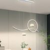 Đèn chùm thiết kế hiện đại này được thiết kế theo phong cách tối giản nhưng đầy nghệ thuật với phần khung kim loại uốn lượn tinh tế. Kết hợp hài hòa giữa đường cong mềm mại và vòng tròn sáng tạo. Hai chao đèn thả thủy tinh đi kèm chi tiết viền ánh kim tạo hiệu ứng phản chiếu ánh sáng đẹp mắt. Mang đến cảm giác ấm cúng nhưng không kém phần sang trọng cho không gian bàn ăn.